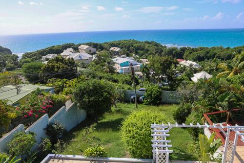 a view of the ocean from a house at Villa Constellation vue Mer piscine et plage à pied in Le Gosier