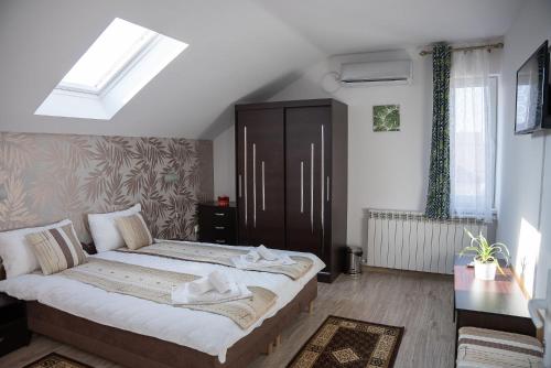 a bedroom with a large bed in a room at Pensiunea Florentina Suceava in Suceava
