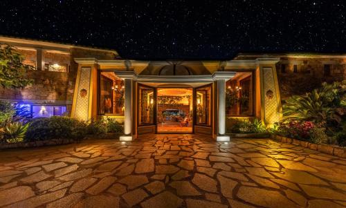 an entrance to a home at night with lights at Hotel & SPA des Pecheurs in Bonifacio