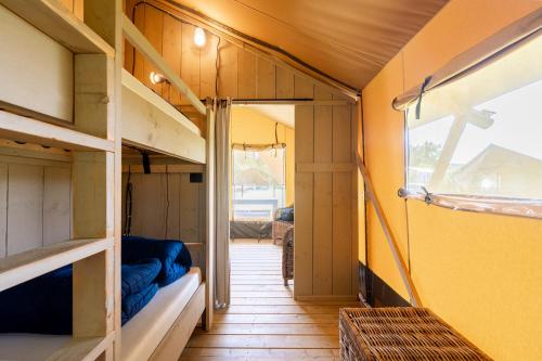a tiny house with a hallway with a couch in it at Glamping Florence in Troghi