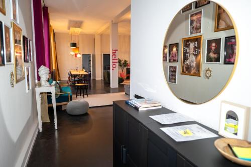 a room with a desk with a mirror and a dining room at 135qm Loft vor den Toren Hamburgs in Schenefeld