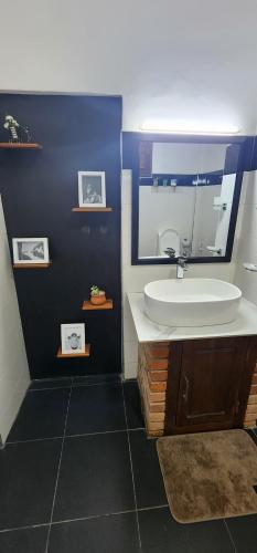 a bathroom with a sink and a mirror at Poomaz Peace Palace in Ella