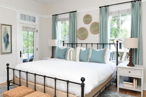 a bedroom with a large bed with blue pillows at 3 Bedroom Wilson Village Home 23 in Bluffton