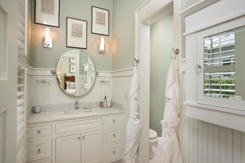 a bathroom with a sink and a mirror at 4 Bedroom Wilson Village Home 43 in Bluffton