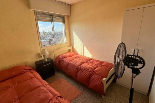 a bedroom with two beds and a window at Buena Vista in Paysandú