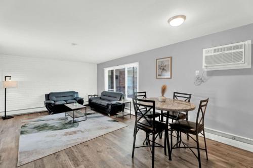 a living room with a table and chairs at Central Home and Serene WiFi Pet Friendly in Sterling Heights