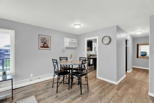 a dining room and living room with a table and chairs at Central Home and Serene WiFi Pet Friendly in Sterling Heights