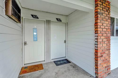 a garage with two white doors and a brick wall at Central Home and Serene WiFi Pet Friendly in Sterling Heights