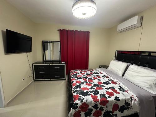 a bedroom with a bed and a red curtain at Don Fernando in Santiago de los Caballeros