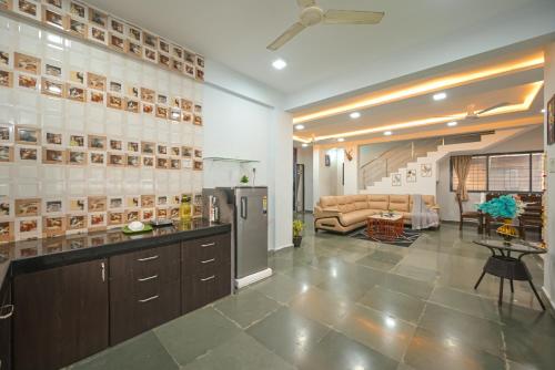 a kitchen with a counter and a living room at ll EMPYREAN STAY II LUXURY ll CELESTIAL UNICORN VILLA ll 3BHK ll AC ll PRIVATE BIG POOL ll in Lonavala