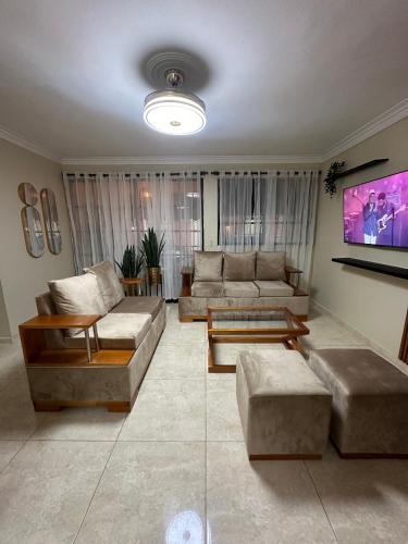 a living room with couches and a flat screen tv at Don Fernando in Santiago de los Caballeros