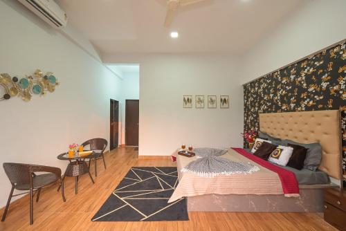 a bedroom with a bed and a table and chairs at ll EMPYREAN STAY II LUXURY ll CELESTIAL UNICORN VILLA ll 3BHK ll AC ll PRIVATE BIG POOL ll in Lonavala
