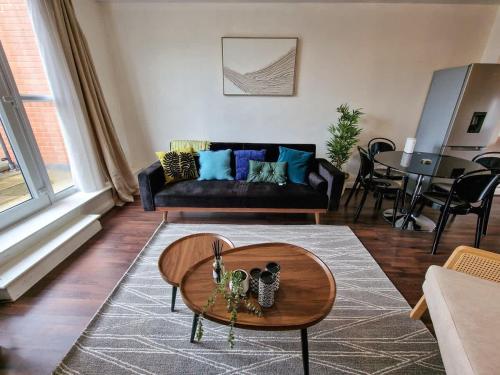 a living room with a couch and a table at Lovely 3 Bed Close to Centre by City SuperHost in Manchester