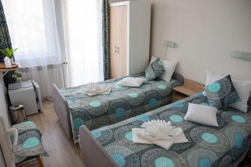 a room with a bed and a couch and a bed and a room with at Pensiunea Florentina Suceava in Suceava