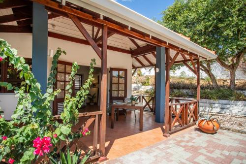 an outdoor patio with a wooden pergola at Bloublou Apartments Curaçao in Jan Thiel