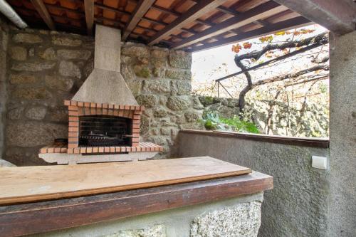 a brick oven sitting on top of a patio at Casa do Adro do Soajo in Soajo
