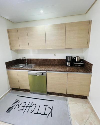 a kitchen with a sink and a counter top at superbe appartement en résidence balnéaire in Bouznika