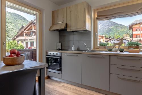 a kitchen with white cabinets and a large window at Giustino in Giustino
