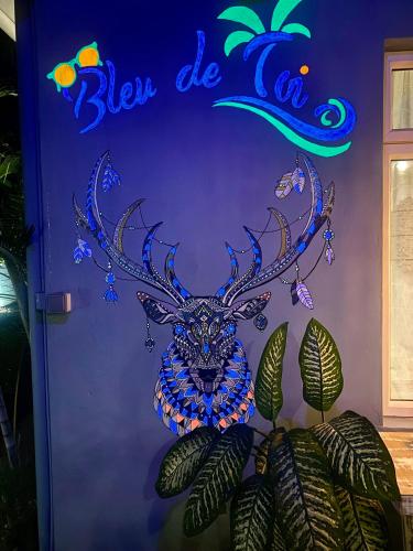 a door with a moose head on the wall at Bleu de Toi Boutique Hotel in Grand Baie