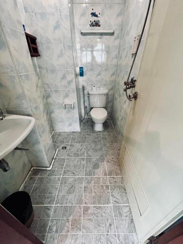 a small bathroom with a toilet and a sink at Centre Point Patong in Patong Beach