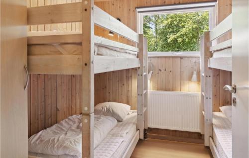 a bunk bed room with two bunk beds and a window at Awesome Home In Dannemare With Sauna in Dannemare