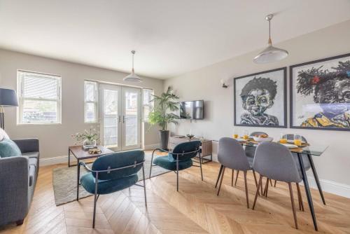 a living room with a dining room table and chairs at Modern 2 Bed Oasis - Private parking & Garden - By Tempstay in Windsor