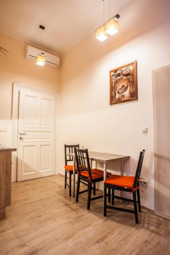 a dining room with a table and chairs at All In Apartman in Budapest