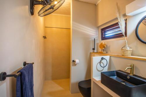 a bathroom with a sink and a toilet at Bloublou Apartments Curaçao in Jan Thiel