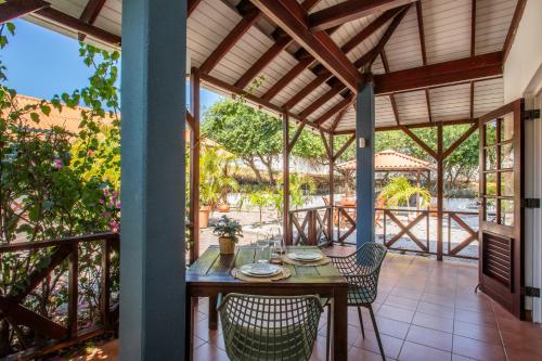 a dining room with a table and chairs on a patio at Bloublou Apartments Curaçao in Jan Thiel