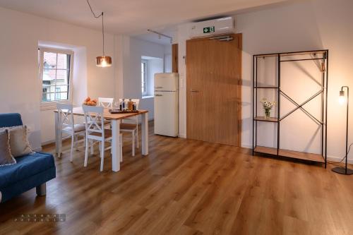 a living room with a table and a refrigerator at Hiša Janko in Dolenjske Toplice