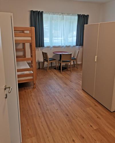 a room with a table and chairs and a table and a room with a table at Ferienwohnungen Hebalm in Pack