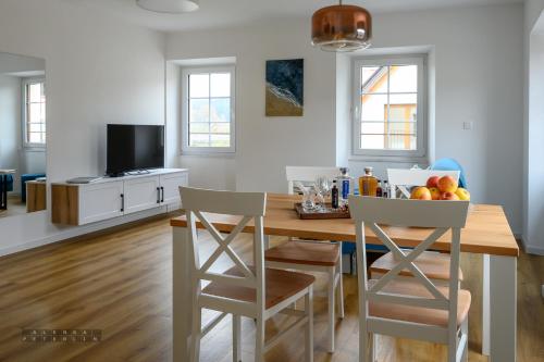 a kitchen and dining room with a wooden table and chairs at Hiša Janko in Dolenjske Toplice