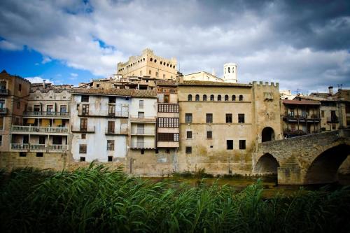 an old building in a city with a bridge at Casa Herrero Valderrobres in Valderrobres