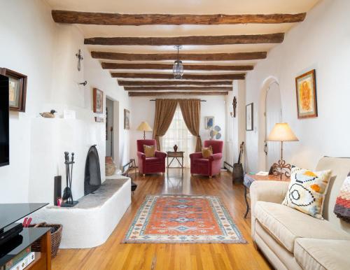 a living room with white walls and a wooden ceiling at Harmony House in Santa Fe