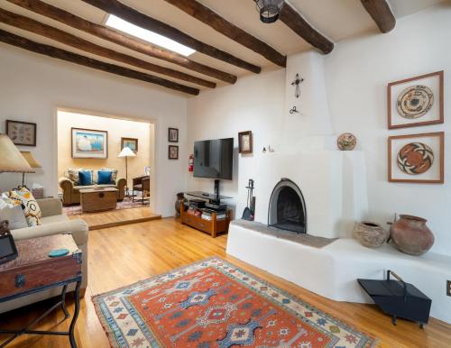 a living room with a fireplace and a tv at Harmony House in Santa Fe