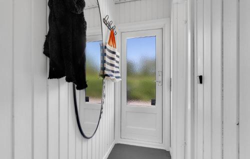 a bathroom with a mirror next to a door at 3 Bedroom Nice Home In Melby in Melby