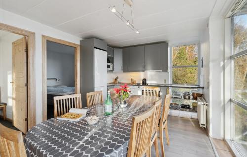 a kitchen and dining room with a table and chairs at Stunning Home In Kruså With Wifi in Rønsheved