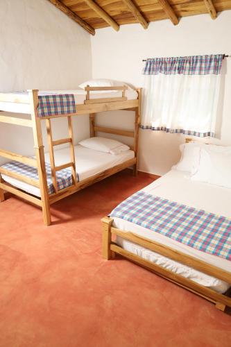 a room with two bunk beds and a chair at Cabañas SALMAGUA in Los Santos