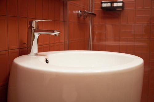 a white sink with a faucet in a bathroom at Bormio Cozy Gem in Bormio