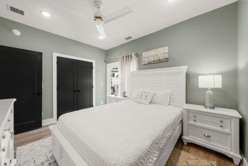 a white bedroom with a white bed and a lamp at Blue Bay Getaway by Pristine Properties in Highland View