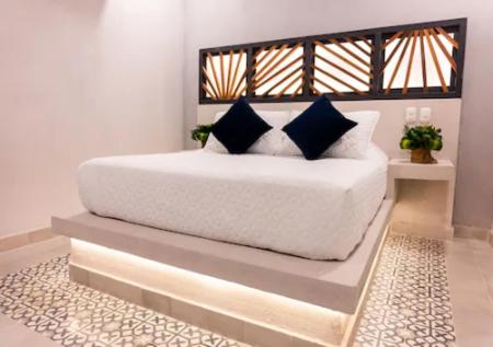 Ένα ή περισσότερα κρεβάτια σε δωμάτιο στο The Garden Suites