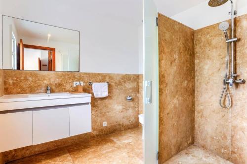 a bathroom with a sink and a shower at Villa Andreu by Villa Plus in El Port