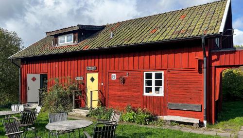 a red barn with a table in front of it at STF Tivedstorp in Tivedstorp