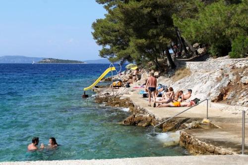 a group of people in the water at a beach at House Nature park in Sali