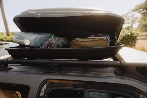 a trunk of a car with luggage on the back at Budget Hack Maui SUV camping in Kahului