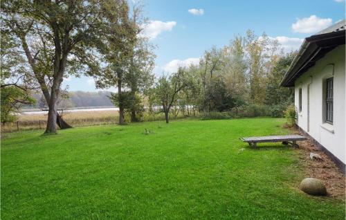 a green yard with a bench in the grass at Gorgeous Home In Næstved in Næstved