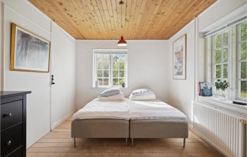 a bedroom with a bed and a wooden ceiling at Gorgeous Home In Næstved in Næstved