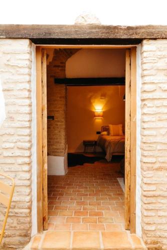 a door into a room with a bed in a bedroom at LAAN Arcos in Arcos de la Frontera