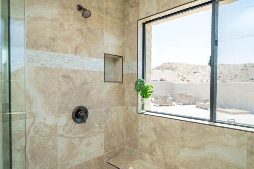 a bathroom with a shower with a glass door at Eagles Lair in Parker
