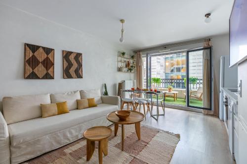 un salon avec un canapé et une table dans l'établissement Oasis Lumineux and the Natural Home a Paris - 8 PAX - 2BR, à Saint-Ouen
